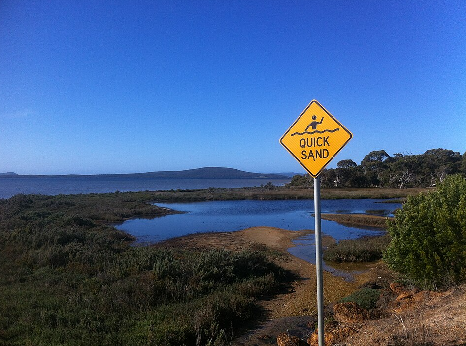 Varning för kvicksand-skylt.